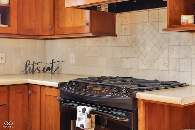 4224 River Rd, Columbus, IN 47203 - kitchen featuring gas stove, ventilation hood, tasteful backsplash, and brown cabinets