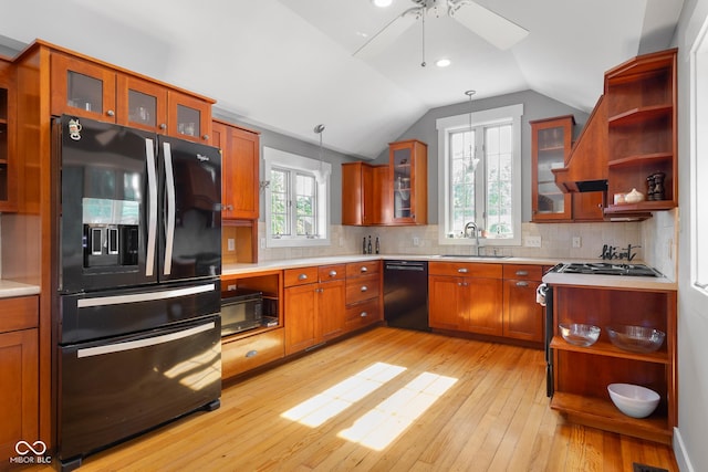 4224 River Rd, Columbus, IN 47203 - kitchen with black appliances, open shelves, brown cabinetry, light countertops, and lofted ceiling