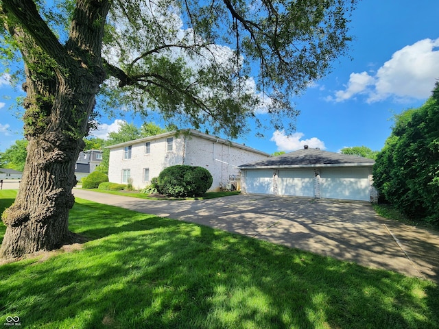 4501 N Wheeling Ave # 5E4, Muncie, IN 47304 - view of property exterior featuring a lawn, a detached garage, and brick siding