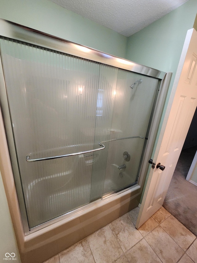 4501 N Wheeling Ave # 5E4, Muncie, IN 47304 - full bathroom with combined bath / shower with glass door and a textured ceiling