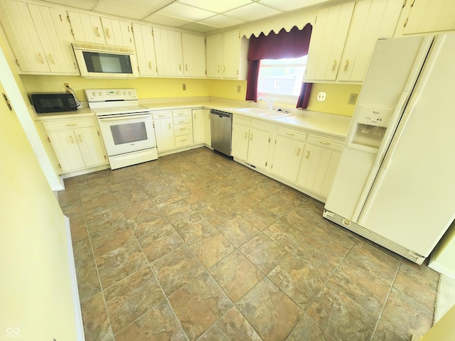 4501 N Wheeling Ave # 5E4, Muncie, IN 47304 - kitchen featuring white appliances, stone finish flooring, light countertops, cream cabinetry, and a drop ceiling