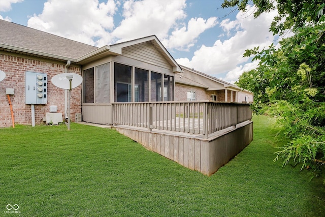 5651 Jones Dr, Plainfield, IN 46168 - view of property exterior with a sunroom, a lawn, a deck, and brick siding