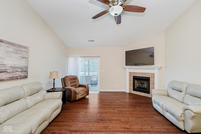5651 Jones Dr, Plainfield, IN 46168 - living area with lofted ceiling, dark wood-style flooring, a ceiling fan, and a tile fireplace