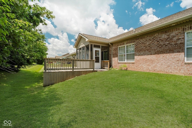 5651 Jones Dr, Plainfield, IN 46168 - rear view of house featuring a sunroom, a lawn, and brick siding