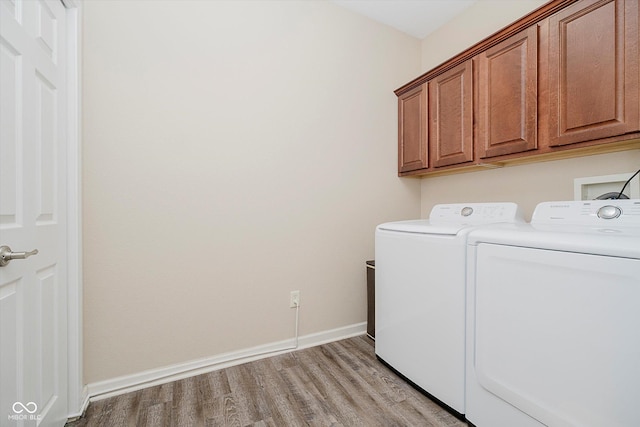 5651 Jones Dr, Plainfield, IN 46168 - laundry area featuring separate washer and dryer, cabinet space, and light wood-style flooring