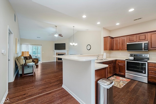 5651 Jones Dr, Plainfield, IN 46168 - kitchen featuring appliances with stainless steel finishes, dark wood finished floors, lofted ceiling, ceiling fan, and light countertops