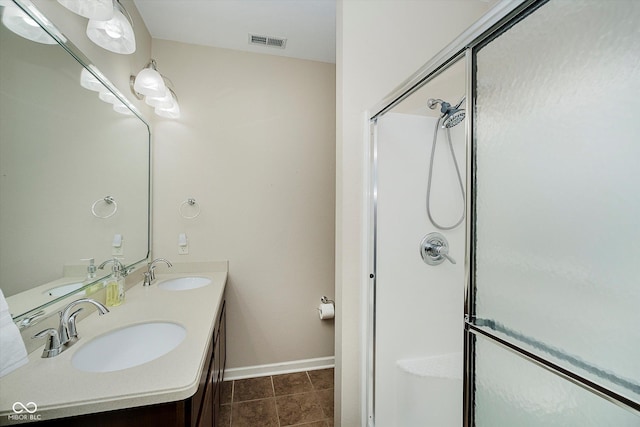 5651 Jones Dr, Plainfield, IN 46168 - full bath featuring a shower stall, double vanity, and tile patterned flooring