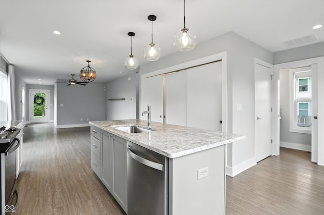 1905 Cornell Ave, Indianapolis, IN 46202 - kitchen featuring dishwasher, wood finished floors, range, light stone countertops, and recessed lighting