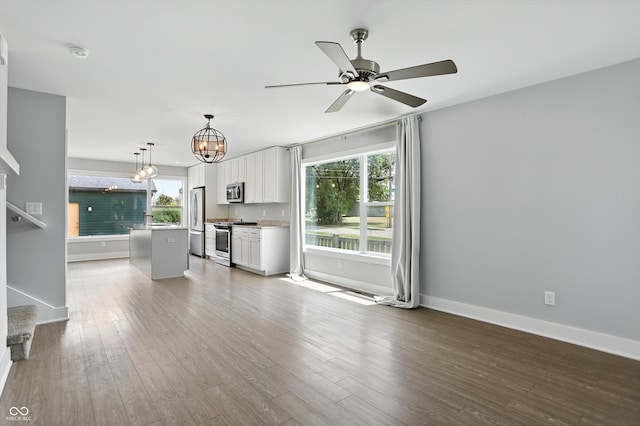 1905 Cornell Ave, Indianapolis, IN 46202 - unfurnished living room featuring a chandelier, wood finished floors, ceiling fan, and stairway