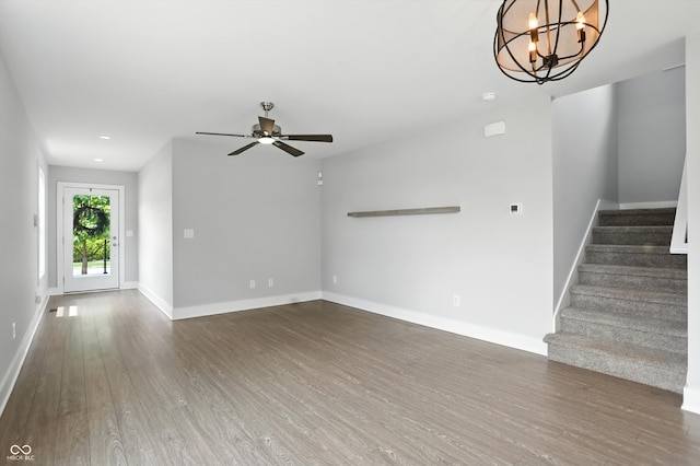 1905 Cornell Ave, Indianapolis, IN 46202 - unfurnished living room with wood finished floors, stairway, a ceiling fan, a chandelier, and recessed lighting