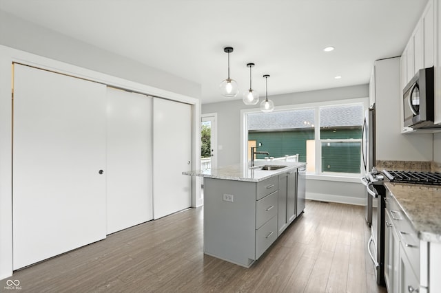 1905 Cornell Ave, Indianapolis, IN 46202 - kitchen with stainless steel appliances, gray cabinets, a center island with sink, dark wood-style flooring, and recessed lighting