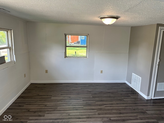 707 S Luick Ave, Muncie, IN 47302 - spare room with a textured ceiling and dark wood-style floors