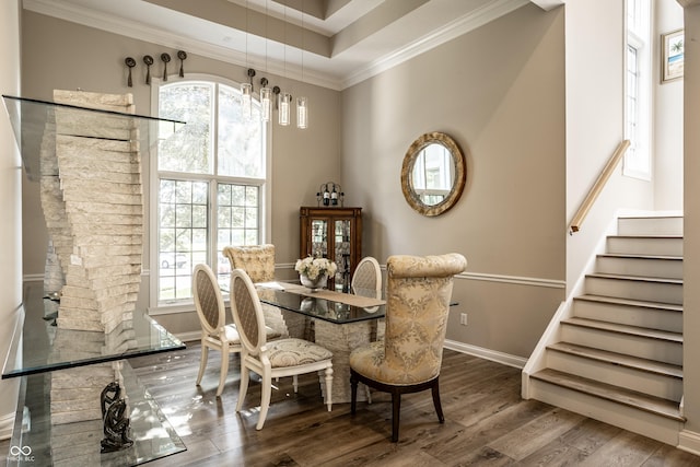 295 Watershed Ct, Noblesville, IN 46062 - dining space featuring crown molding, wood finished floors, stairs, a high ceiling, and a raised ceiling