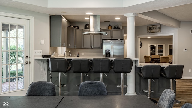 295 Watershed Ct, Noblesville, IN 46062 - kitchen featuring stainless steel fridge with ice dispenser, gray cabinets, a peninsula, a breakfast bar, and recessed lighting