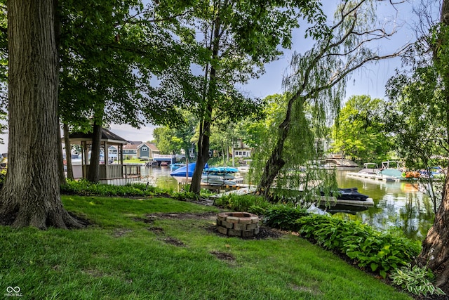 295 Watershed Ct, Noblesville, IN 46062 - view of green lawn featuring an outdoor fire pit, a dock, and a water view