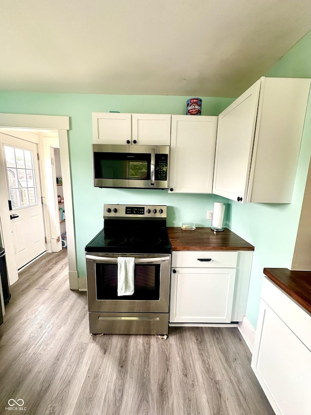 514 E 2nd St, Sheridan, IN 46069 - kitchen featuring appliances with stainless steel finishes, light wood-style flooring, butcher block countertops, and white cabinets