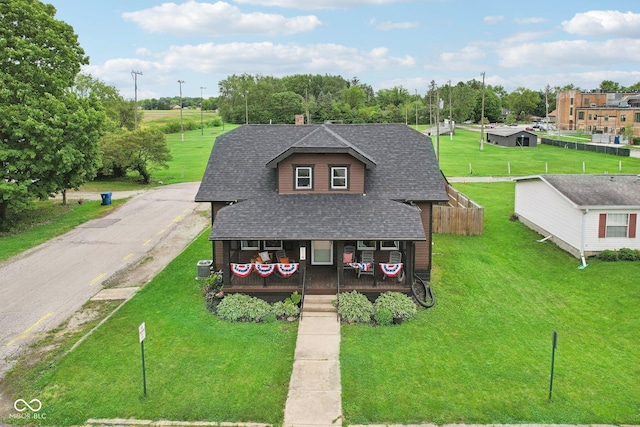 514 E 2nd St, Sheridan, IN 46069 - view of front of property with a porch, roof with shingles, and a front lawn