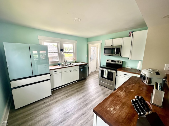514 E 2nd St, Sheridan, IN 46069 - kitchen with stainless steel appliances, butcher block counters, white cabinetry, and light wood finished floors
