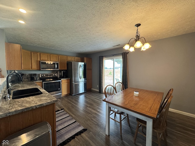 1406 Bigleaf Cir, Sheridan, IN 46069 - kitchen with stainless steel appliances, dark wood-type flooring, a textured ceiling, a chandelier, and recessed lighting