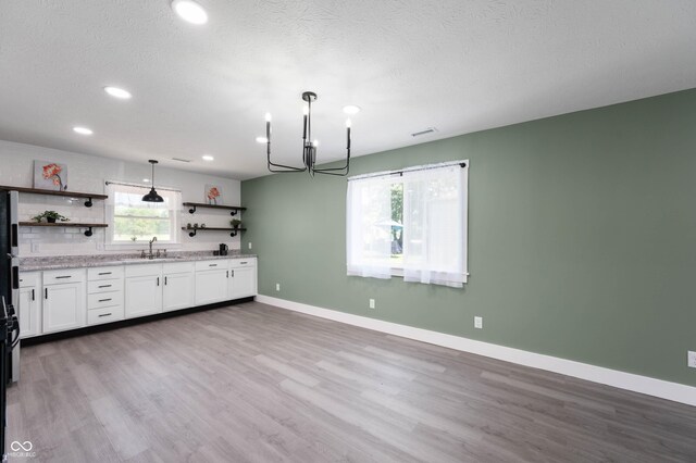 640 N 27th St, New Castle, IN 47362 - kitchen featuring open shelves, a chandelier, white cabinets, wood finished floors, and recessed lighting