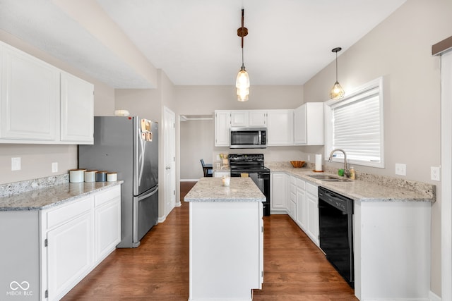 8642 Ray Cir, Indianapolis, IN 46256 - kitchen with black appliances, a kitchen island, wood finished floors, and white cabinets