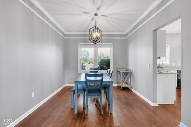 8642 Ray Cir, Indianapolis, IN 46256 - dining space with a chandelier, dark wood-style floors, and ornamental molding