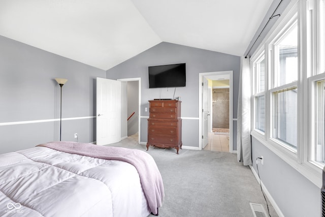 8642 Ray Cir, Indianapolis, IN 46256 - bedroom with vaulted ceiling, light colored carpet, and connected bathroom