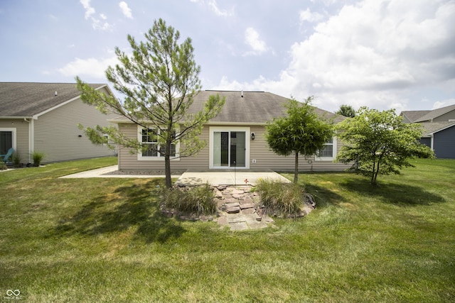 6448 W Whiteside Ct, Greenfield, IN 46140 - back of house featuring a patio, a lawn, and a shingled roof