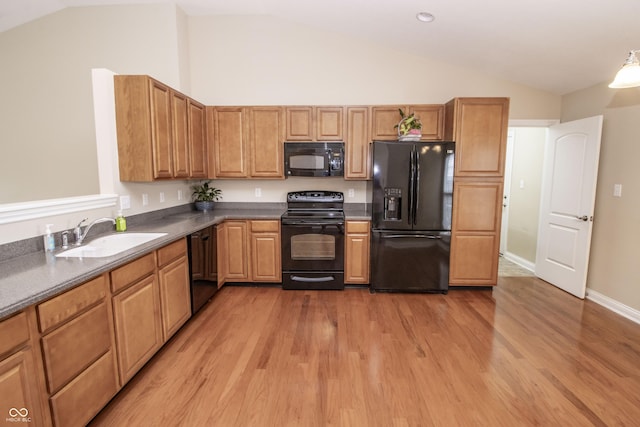 6448 W Whiteside Ct, Greenfield, IN 46140 - kitchen featuring black appliances, vaulted ceiling, light wood-style flooring, and dark countertops