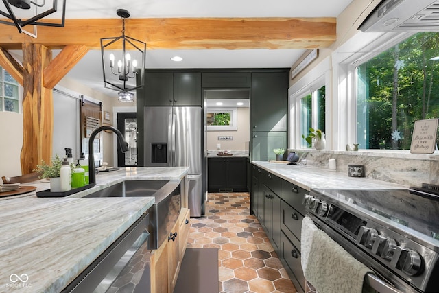2350 E County Road 20 N, North Vernon, IN 47265 - kitchen with appliances with stainless steel finishes, a barn door, dark cabinetry, light stone countertops, and pendant lighting
