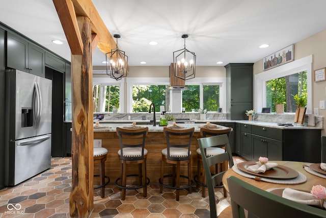 2350 E County Road 20 N, North Vernon, IN 47265 - kitchen featuring stainless steel fridge with ice dispenser, a chandelier, tasteful backsplash, recessed lighting, and light stone counters