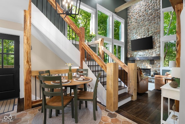 2350 E County Road 20 N, North Vernon, IN 47265 - stairway featuring a stone fireplace, a chandelier, and a towering ceiling