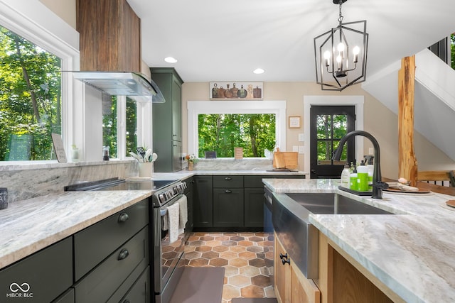 2350 E County Road 20 N, North Vernon, IN 47265 - kitchen with stainless steel range with electric stovetop, premium range hood, plenty of natural light, light stone counters, and recessed lighting