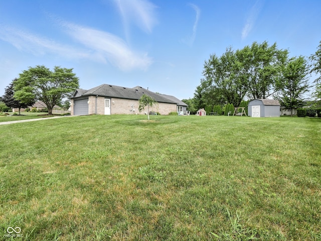856 Cypress N, Greenwood, IN 46143 - view of green lawn with an attached garage and a shed