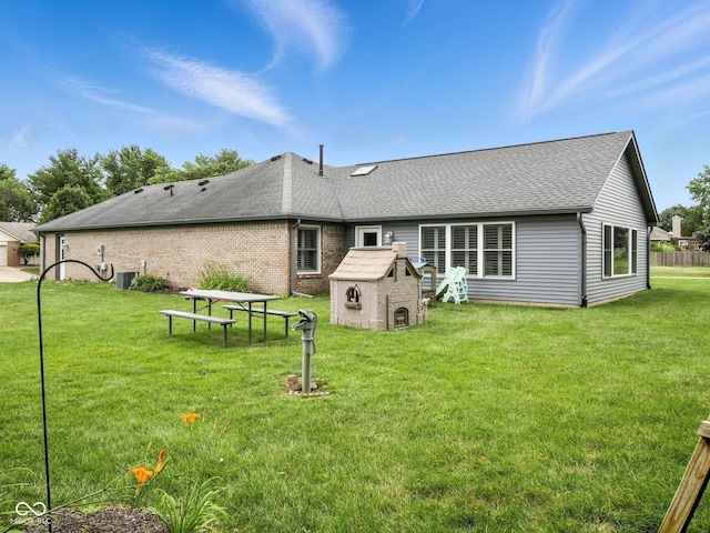 856 Cypress N, Greenwood, IN 46143 - rear view of property featuring roof with shingles, a shed, a lawn, and brick siding