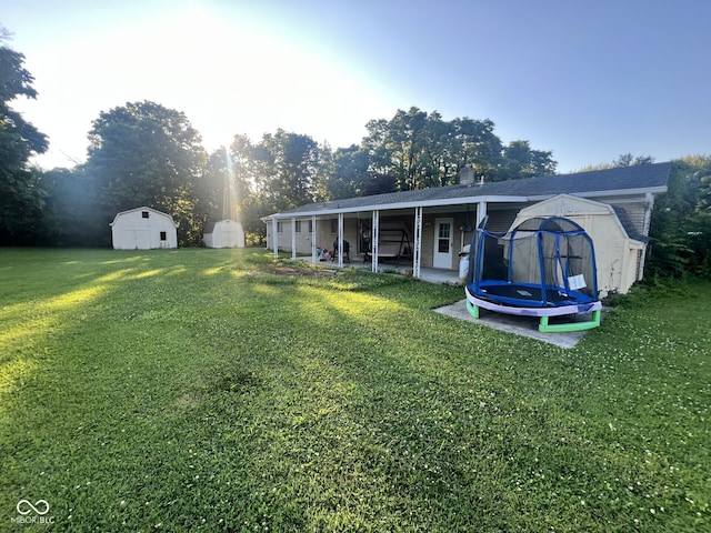 207 W Elm St, Spiceland, IN 47385 - view of green lawn with a shed and a trampoline