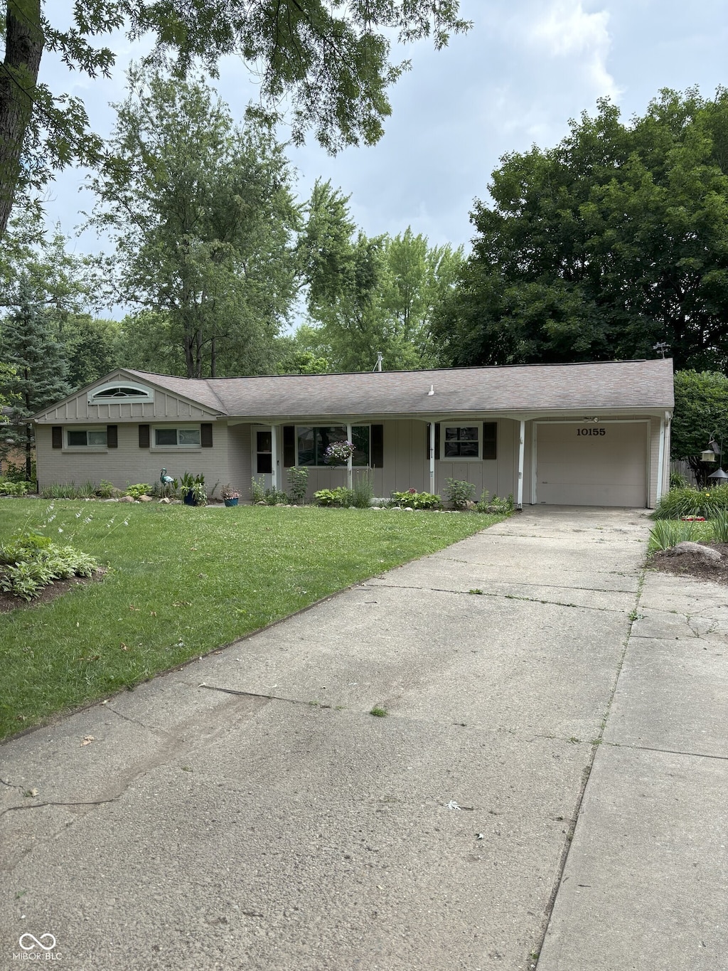 10155 Orchard Park Dr W, Carmel, IN 46280 - single story home featuring an attached garage, a front yard, and concrete driveway