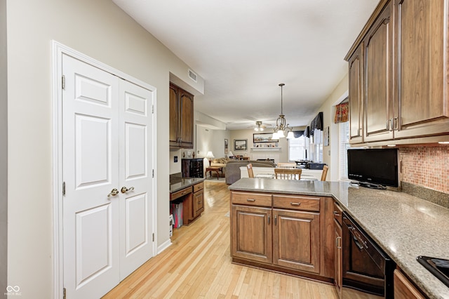 6813 Bluffgrove Dr, Indianapolis, IN 46278 - kitchen with open floor plan, a peninsula, light wood-style flooring, pendant lighting, and decorative backsplash