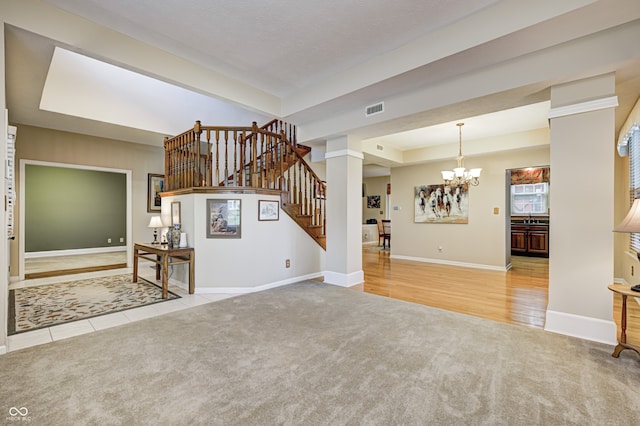 6813 Bluffgrove Dr, Indianapolis, IN 46278 - unfurnished living room featuring carpet flooring, a raised ceiling, a chandelier, and stairs