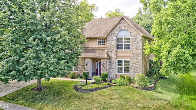 6813 Bluffgrove Dr, Indianapolis, IN 46278 - view of front of home featuring a front yard, brick siding, and a shingled roof