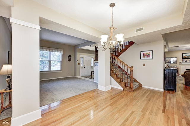 6813 Bluffgrove Dr, Indianapolis, IN 46278 - entryway featuring light wood-type flooring, a chandelier, and stairs