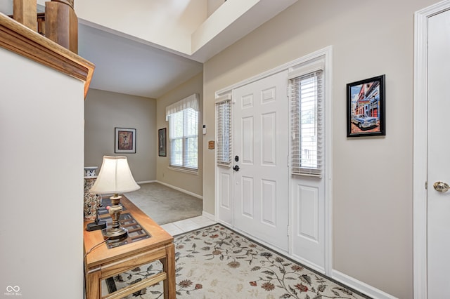 6813 Bluffgrove Dr, Indianapolis, IN 46278 - foyer with light carpet and light tile patterned floors