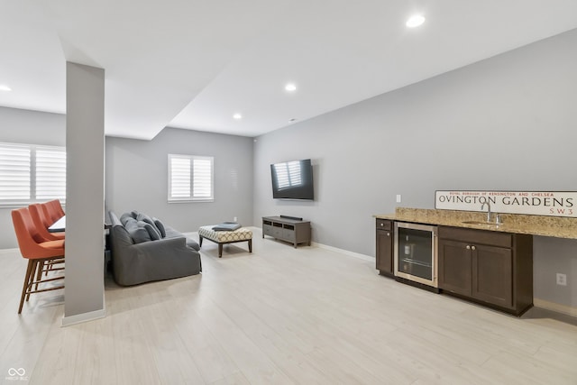 10795 Creekbed Cir, Fishers, IN 46038 - living room with beverage cooler, recessed lighting, light wood-style floors, and bar