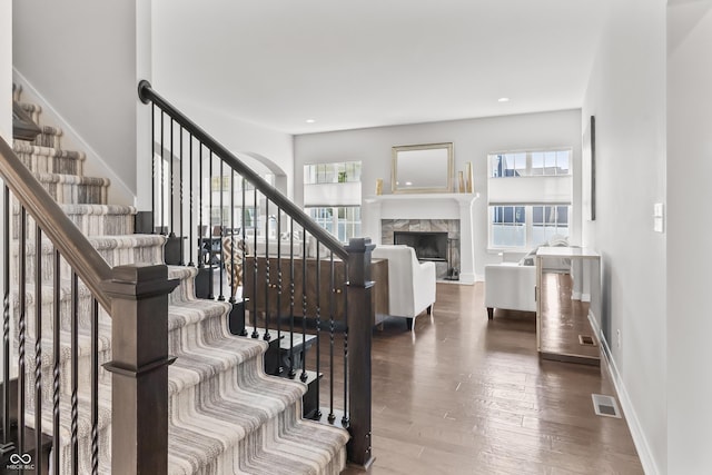 10795 Creekbed Cir, Fishers, IN 46038 - staircase featuring healthy amount of natural light, wood finished floors, a premium fireplace, and recessed lighting