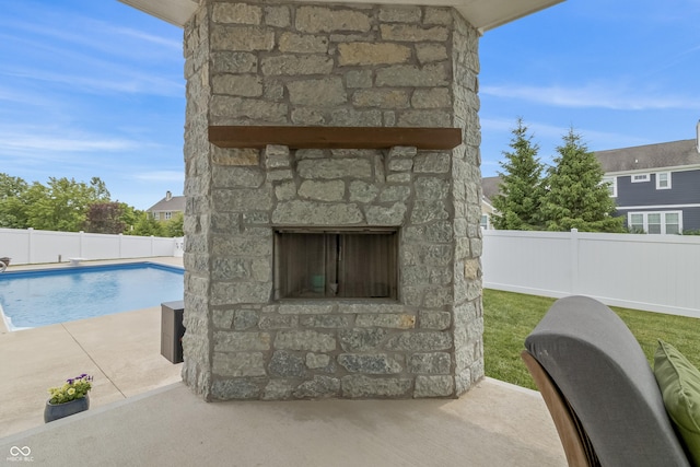 10795 Creekbed Cir, Fishers, IN 46038 - view of swimming pool with an outdoor stone fireplace, a patio, and a fenced backyard
