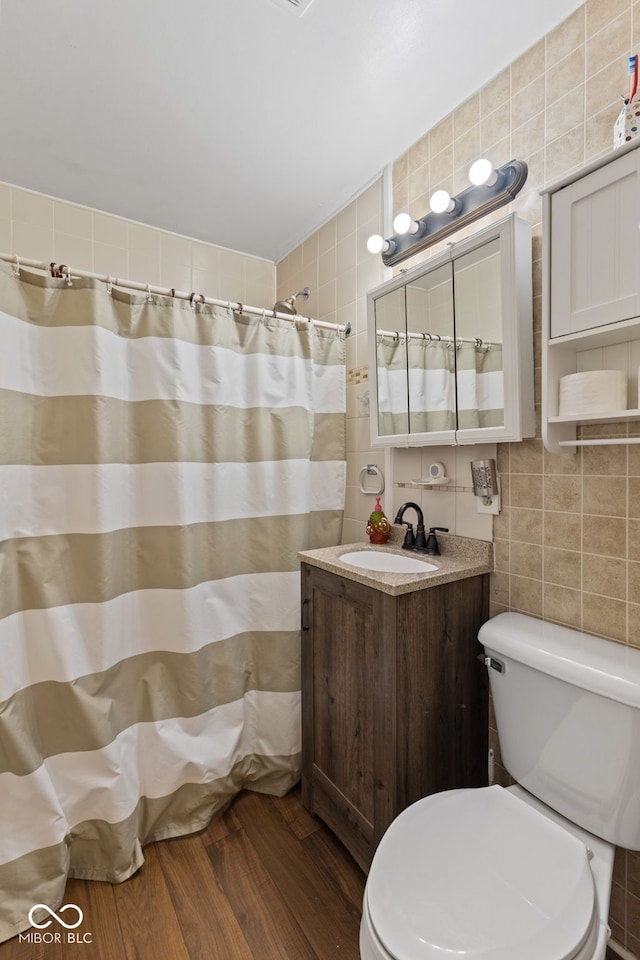 2017 E Legrande Ave, Indianapolis, IN 46203 - full bathroom featuring tile walls, vanity, wood finished floors, and curtained shower