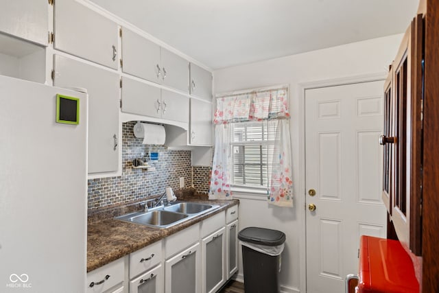 2017 E Legrande Ave, Indianapolis, IN 46203 - kitchen with freestanding refrigerator, dark countertops, and backsplash
