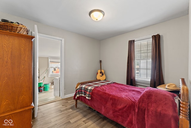 2017 E Legrande Ave, Indianapolis, IN 46203 - bedroom featuring multiple windows and wood finished floors