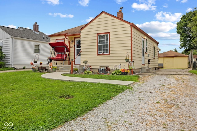 2017 E Legrande Ave, Indianapolis, IN 46203 - bungalow-style house with a front lawn, a chimney, and driveway