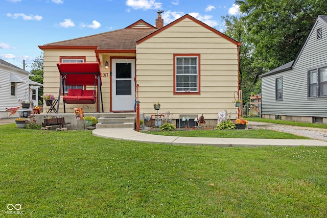 2017 E Legrande Ave, Indianapolis, IN 46203 - bungalow with a front yard, a shingled roof, a chimney, and entry steps